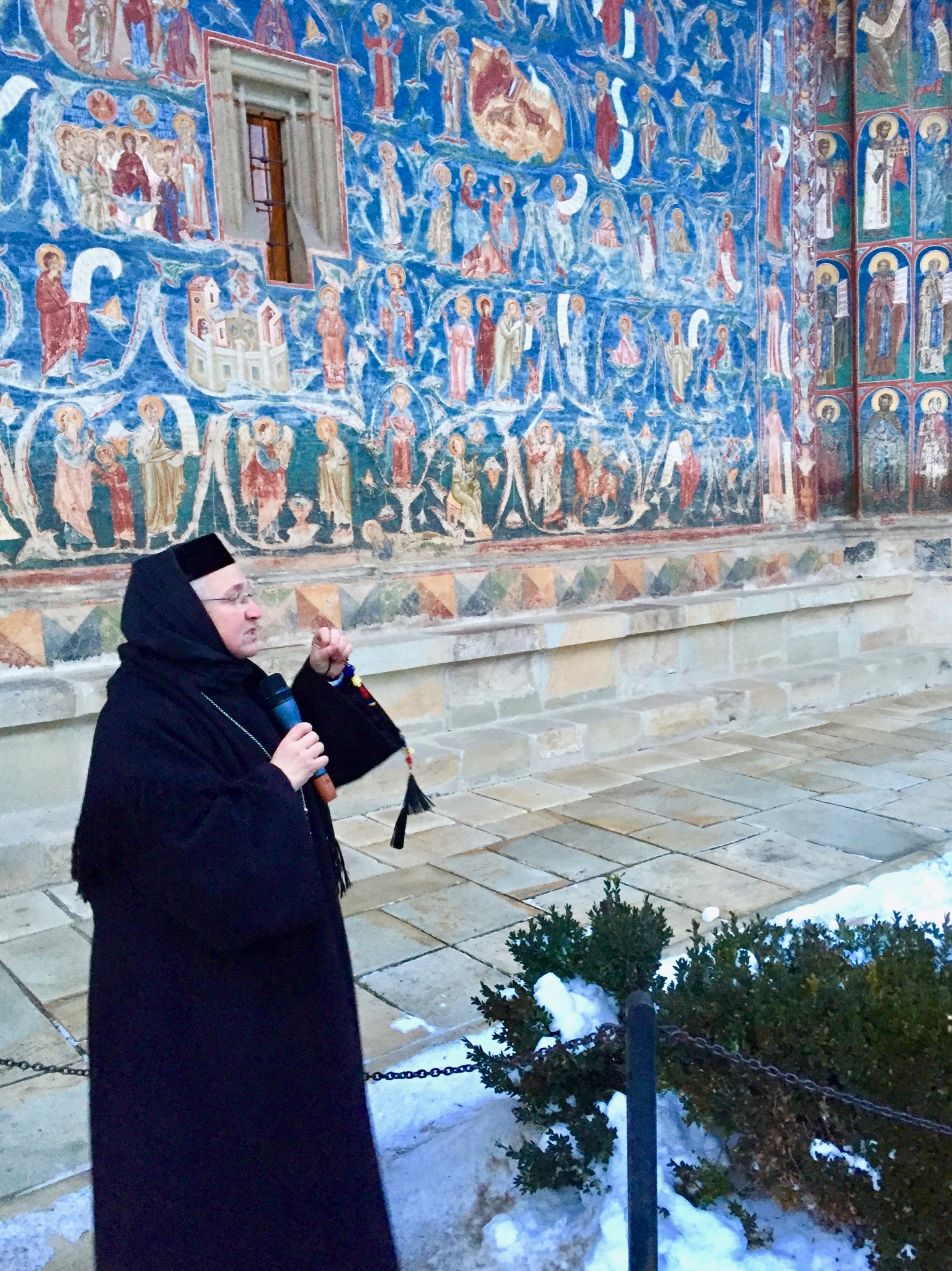 Nun in front of blue wall in Iasi, Romania Nun in front of blue wall in Iasi, Romania